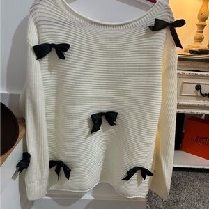 Off the Shoulder Cream Sweater with Black Bow Accents